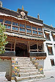 Ladakh - Sankar gompa (Leh), the main monastery halls with the characteristc red painted windows and woden balconies on white washed faades 